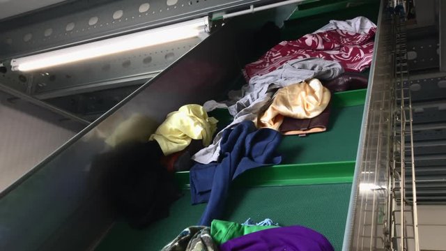 clothes going up on a conveyor belt, ready to sort out