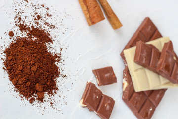 Coffee,white and milk chocolate. Tiles of chocolate on a white background.