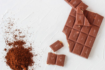 Coffee,white and milk chocolate. Tiles of chocolate on a white background.