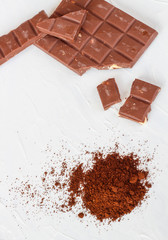 Coffee,white and milk chocolate. Tiles of chocolate on a white background.