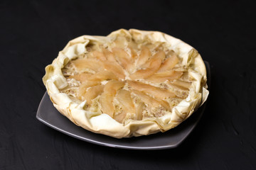 Apple cake with almond cream on a dark background. Baked cake. Casserole Cooked in multivarts Proper nutrition. Pie for the whole family on a sunny day