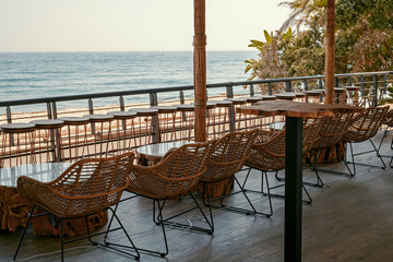 tables and chairs on the terrace by the sea in Marbella city, Spain