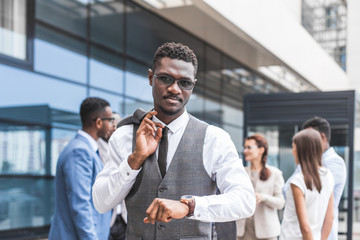 Portrait of an handsome businessman in front of his team. recognition, movement on the career ladder, success in business