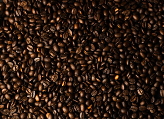 Coffee grains on a dark background. A delicious fragrant coffee of the best varieties. Coffee...