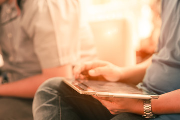 close up hands multitasking man using table connecting wifi.Business Project.Touching Screen Digital Tablet. Horizontal. Film effect. Blurred background. Flares