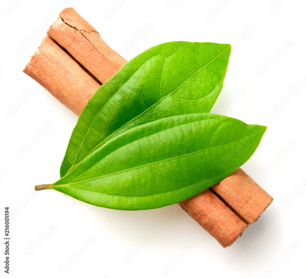 Wall mural fresh cinnamon leaves and stick isolated on white, top view