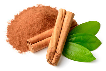 cinnamon powder and sticks with fresh leaves isolated on white