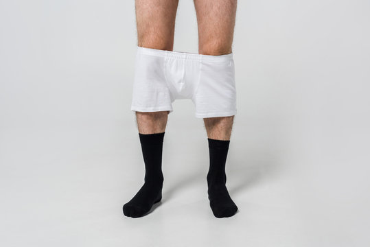 Cropped Shot Of Man In Black Socks With White Underwear On Grey Backdrop