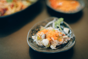 Flying fish roe (Tobiko) on black dish