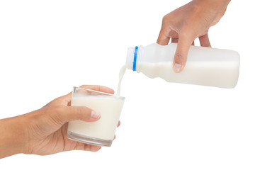 Pouring milk into glass isolated on white background - clipping paths