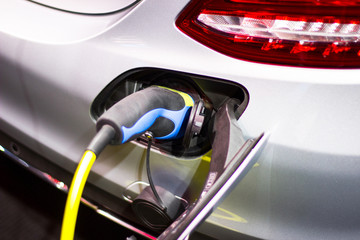 Fototapeta premium the charging the battery for the car new Automotive Innovations the power supply plugged into an electric car being charged.