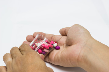 The many pill and capsules in hand man -  isolated white background