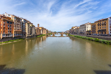Naklejka na ściany i meble Colorful old buildings line the Arno River in Florence, Italy