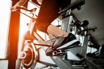 Fitness woman working out on exercise bike at the gym.exercising concept.fitness and healthy...