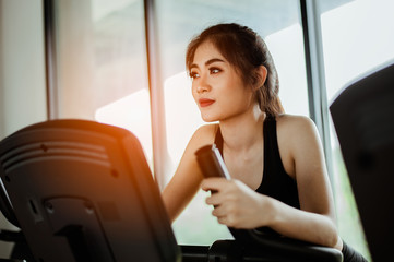 Fitness woman working out on exercise bike at the gym.exercising concept.fitness and healthy lifestyle