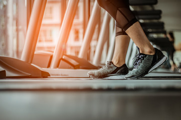 Close up on shoe,Women running in a gym on a treadmill.exercising concept.fitness and healthy lifestyle