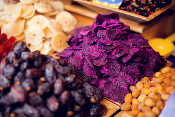 Dried fruit background. Rows of dried dates, apricots,cranberries, pomelos, prunes and figs.