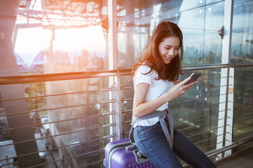 Women are using their smartphones to Flight Checking at airports.airports and technology concept