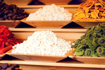 Dried fruit background. Rows of dried dates, apricots,cranberries, pomelos, prunes and figs.