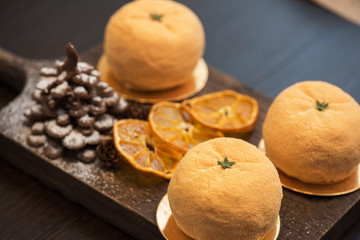 Tasty dessert as orange fruit with chocolate fir-tree for new year holiday