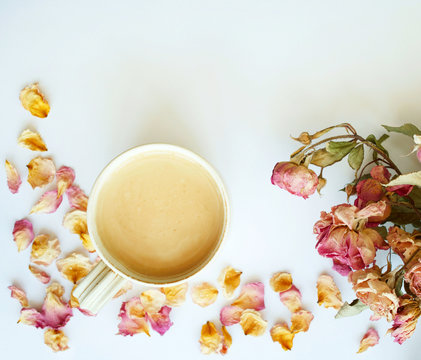 Picture of autumn background with dry roses and cup of coffee with copy space