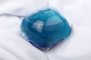 Single laundry detergent pod (or pack) on a white cloth
