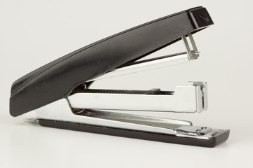 stapler for stapling papers on a table