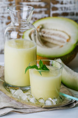 melon smoothie in glass and bottle on white background, summer drink, cocktail