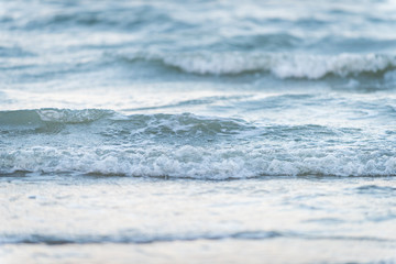 Naklejka na ściany i meble Wave of the sea on the sand beach