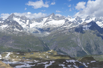 Distant steep rocky snow-capped alpine summit in Valais - Swiss Alps