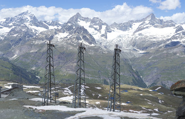 Power lines in ta mountain landscape in the swiss alps