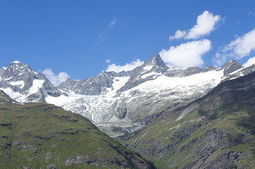 Fototapeta na wymiar Distant steep rocky snow-capped alpine summit in Valais - Swiss Alps