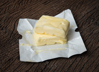 Piece of butter on wooden background