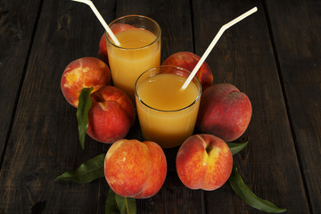 Peach fresh juice with fresh peaches on a dark background. Top view, copy space. Healthy eating. Fresh juice with peach.
