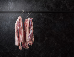Pork hanging on hook against dark background,Pork  belly © showcake
