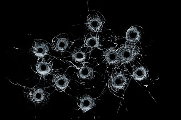Broken glass multiple bullet holes in glass isolated on black - obrazy, fototapety, plakaty