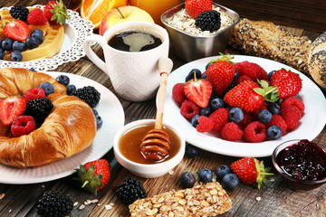 breakfast on table with waffles, croissants, coffe and juice.