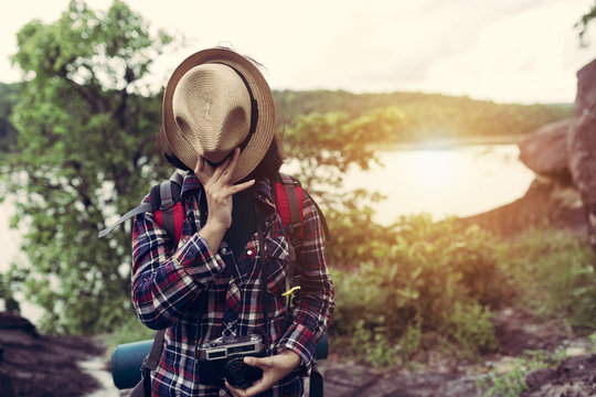 Hipster style women backpacker traveller standing hat off