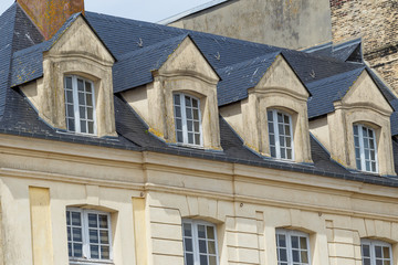 Obraz premium Facades of traditional residential houses with mansard stores in Dieppe, Normandy region, France. Norman style old houses. Beautiful european cityscape with typical french architecture