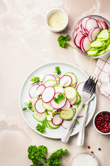 Fototapeta na wymiar Summer vegetarian radish, cucumber feta salad. Top view, space for text.