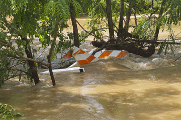 Barricade Submerged in Flooded River
