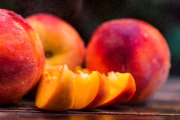 Fototapeta na wymiar Fresh ripe peaches and slices on wooden table