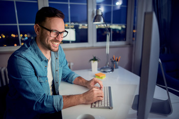 Man working on computer late at night