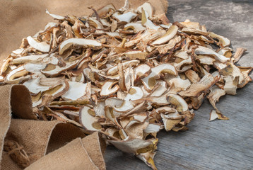 Dried porcini mushrooms on a wooden table.