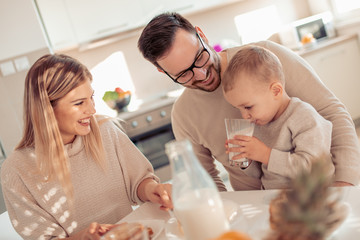 Happy family having breakfast at home