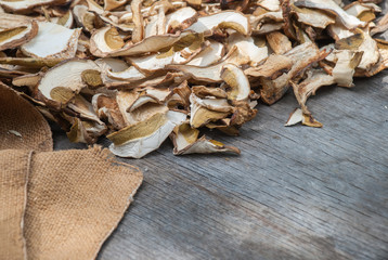 Dried porcini mushrooms on a wooden table.
