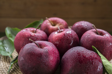 Fresh organic ripe apple fruits on old wooden table.