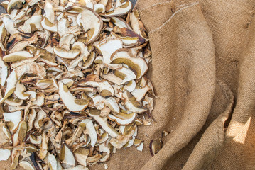 Dried porcini mushrooms on a wooden table.