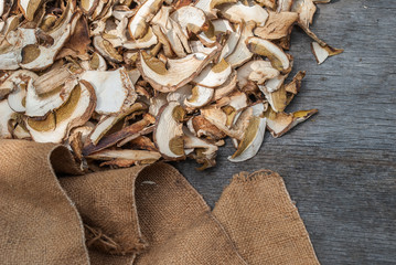 Dried porcini mushrooms on a wooden table.
