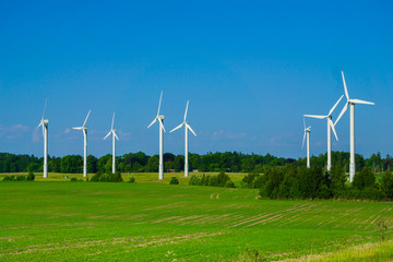 Windmill type wind electricity generator in the field in Latvia in summer